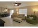 Bright living room featuring tile floors, comfortable seating, and a decorative ceiling fan at 1135 Easley Way, The Villages, FL 32162