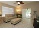 Bright living room with tiled floors, neutral walls, ceiling fan, and comfortable seating at 1135 Easley Way, The Villages, FL 32162