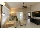 Bright living room with tiled floors, neutral walls, ceiling fan, and comfortable seating at 1135 Easley Way, The Villages, FL 32162