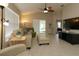 Bright living room with tiled floors, neutral walls, ceiling fan, and comfortable seating at 1135 Easley Way, The Villages, FL 32162