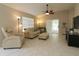 Bright living room with tiled floors, neutral walls, ceiling fan, and comfortable seating at 1135 Easley Way, The Villages, FL 32162