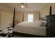 Brightly lit bedroom featuring a four-poster bed, ceiling fan, and natural light at 1135 Easley Way, The Villages, FL 32162
