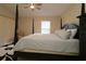Bright bedroom with four-poster bed and a window, ceiling fan, and adjacent dresser at 1135 Easley Way, The Villages, FL 32162