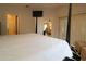 Spacious main bedroom featuring a four-poster bed and ensuite bath for primary occupant comfort at 1135 Easley Way, The Villages, FL 32162