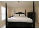 Brightly lit bedroom with a four-poster bed, ceiling fan, and ensuite bath at 1135 Easley Way, The Villages, FL 32162