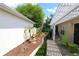 Landscaped backyard patio with white pergola and a green outdoor chair on a brick surface, great for outdoor relaxing at 1135 Easley Way, The Villages, FL 32162