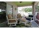 Inviting screened patio with comfortable seating and colorful decor, great for relaxing outdoors at 1135 Easley Way, The Villages, FL 32162