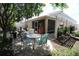 Charming patio area featuring a screened enclosure, a white pergola, and outdoor seating at 1135 Easley Way, The Villages, FL 32162