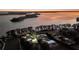 Aerial view of lakefront homes at sunset with expansive shoreline at 11619 Lane Park Rd, Tavares, FL 32778