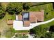 Aerial view highlighting the pool enclosure, meticulously maintained yard, and concrete driveway at 11619 Lane Park Rd, Tavares, FL 32778