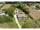 Charming home with solar panels, green lawn, mature landscaping, and a long driveway at 11619 Lane Park Rd, Tavares, FL 32778