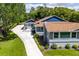Aerial view of home with a long driveway, gray exterior, and a brown roof at 11619 Lane Park Rd, Tavares, FL 32778