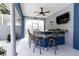 Outdoor wet bar featuring stone accents, bar seating, and a ceiling fan at 11619 Lane Park Rd, Tavares, FL 32778