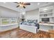 Bedroom with custom built-ins, wood floors, and window overlooking the water at 11619 Lane Park Rd, Tavares, FL 32778