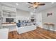 Stylish bedroom features built-in shelving, desk area, hardwood floors, and a ceiling fan at 11619 Lane Park Rd, Tavares, FL 32778