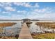 Picturesque dock with a covered boat slip, offering stunning lake views and waterfront living at 11619 Lane Park Rd, Tavares, FL 32778