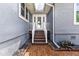 Home entrance featuring covered stairway, double doors, and bricked walkway at 11619 Lane Park Rd, Tavares, FL 32778