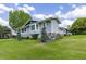 Well-maintained home with lush green lawn and mature landscaping at 11619 Lane Park Rd, Tavares, FL 32778