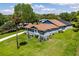 Attractive single-Gathering home with a well-manicured lawn, screened lanai, and lush landscaping at 11619 Lane Park Rd, Tavares, FL 32778