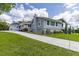 Home exterior featuring well maintained lawn and long concrete driveway at 11619 Lane Park Rd, Tavares, FL 32778
