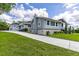 Charming single-story house features a long driveway, well-manicured lawn, and inviting architecture, bathed in natural light at 11619 Lane Park Rd, Tavares, FL 32778