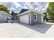 Attached two-car garage with white door, and driveway with parking at 11619 Lane Park Rd, Tavares, FL 32778