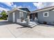 Gray house exterior with concrete steps leading to a screened-in porch at 11619 Lane Park Rd, Tavares, FL 32778