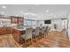 Open-concept kitchen with a large island, breakfast bar seating, and wood flooring throughout at 11619 Lane Park Rd, Tavares, FL 32778