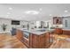 Spacious kitchen featuring a large island with stone countertop, modern appliances, and elegant finishes at 11619 Lane Park Rd, Tavares, FL 32778