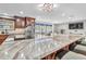 Modern kitchen features a large granite island, bar seating and stainless appliances at 11619 Lane Park Rd, Tavares, FL 32778