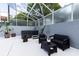 Outdoor lanai with a hot tub, lounge seating, and screened enclosure for privacy at 11619 Lane Park Rd, Tavares, FL 32778