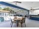 Inviting screened-in lanai with a pool, dining area, and a wet bar for outdoor entertaining at 11619 Lane Park Rd, Tavares, FL 32778