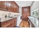 Laundry room boasts granite counters, wood cabinets and modern washer and dryer at 11619 Lane Park Rd, Tavares, FL 32778