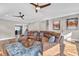 Spacious living room with ceiling fans, modern decor, and comfortable leather seating at 11619 Lane Park Rd, Tavares, FL 32778