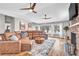Spacious living room with stone fireplace and picturesque windows overlooking the lake at 11619 Lane Park Rd, Tavares, FL 32778