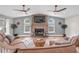 Cozy living room with stone fireplace, hardwood floors, and lake views at 11619 Lane Park Rd, Tavares, FL 32778