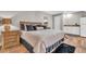 Comfortable bedroom with king bed, wood floors, and kitchenette area at 11619 Lane Park Rd, Tavares, FL 32778
