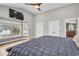 Main bedroom featuring wood floors, ensuite bathroom access, and beautiful lake views at 11619 Lane Park Rd, Tavares, FL 32778