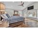 Main bedroom boasts a vaulted ceiling, wood floors, and a view of the lake at 11619 Lane Park Rd, Tavares, FL 32778