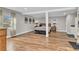 Spacious main bedroom with laminate flooring, art deco accents, and natural light streaming through the window at 11619 Lane Park Rd, Tavares, FL 32778