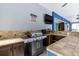 Outdoor kitchen featuring stainless steel grill, tile countertops, and ceiling fan at 11619 Lane Park Rd, Tavares, FL 32778