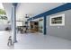Covered patio with ceiling fans, dining table, and access to the home's interior through sliding glass doors at 11619 Lane Park Rd, Tavares, FL 32778