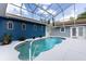 Beautiful in-ground pool surrounded by white patio, with decorative architectural touches at 11619 Lane Park Rd, Tavares, FL 32778