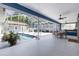 An inviting screened-in pool area featuring a pool, hot tub, dining area, and a relaxing lounge space at 11619 Lane Park Rd, Tavares, FL 32778