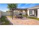 Outdoor space features a brick paver patio, pergola, grill, and dining set at 118 Green Branch Blvd, Groveland, FL 34736