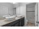 Bathroom boasts double vessel sinks on dark cabinets, with a tub/shower combo at 118 Green Branch Blvd, Groveland, FL 34736