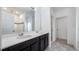 Bathroom featuring dual sinks with dark cabinets, tile floors, large mirror and bright lighting at 118 Green Branch Blvd, Groveland, FL 34736