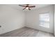 Bedroom featuring wood-look flooring, a ceiling fan, and a sunny window at 118 Green Branch Blvd, Groveland, FL 34736