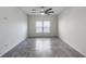 Bedroom with window, ceiling fan, tile floors, and plenty of natural light at 118 Green Branch Blvd, Groveland, FL 34736