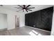 Bedroom featuring hardwood floors, a modern accent wall, ceiling fan, and window with bright natural light at 118 Green Branch Blvd, Groveland, FL 34736